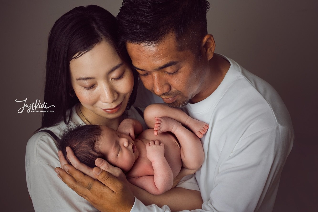 Parents Holding The Infant